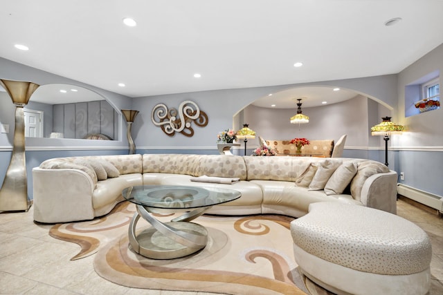 living room featuring arched walkways, baseboard heating, and recessed lighting