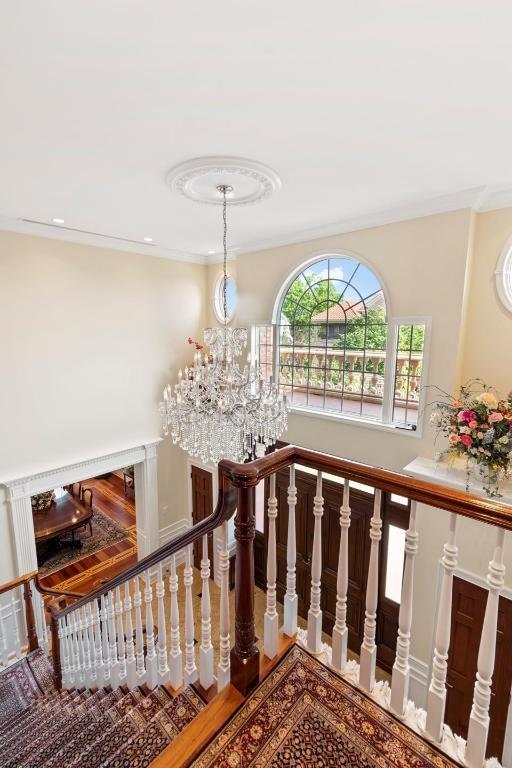 staircase featuring an inviting chandelier