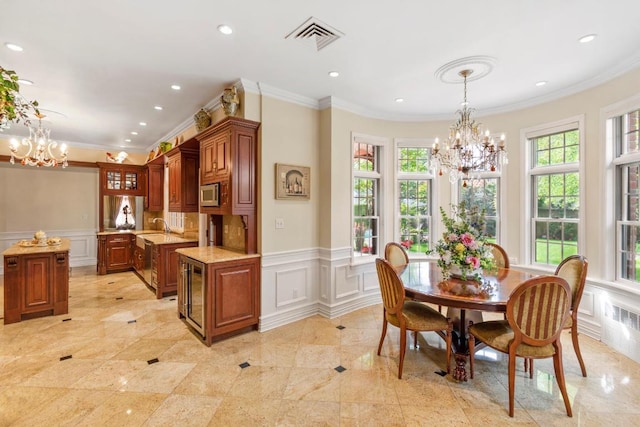 interior space featuring ornamental molding, sink, and a chandelier