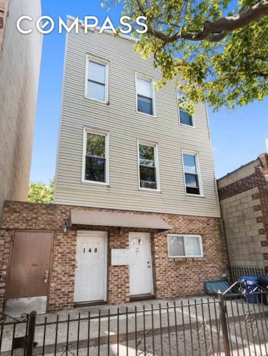 exterior space featuring brick siding and a fenced front yard