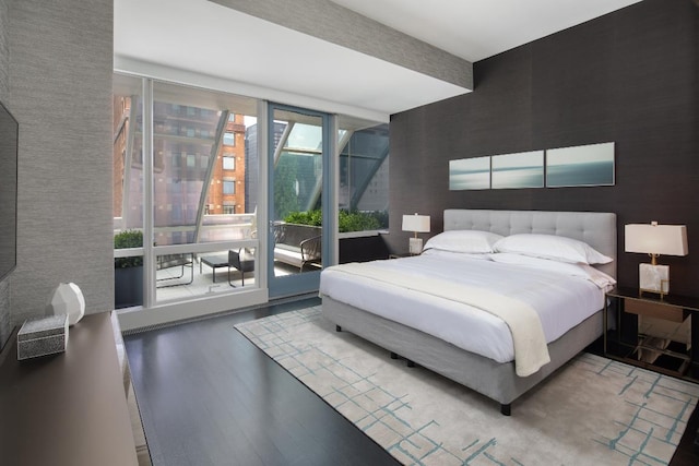 bedroom featuring wood-type flooring and access to outside