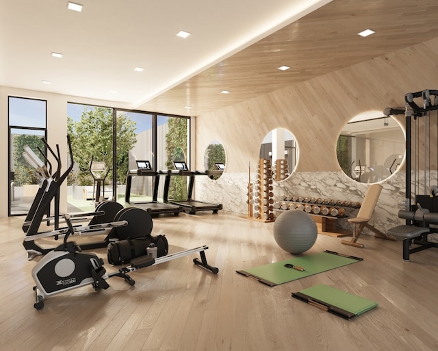 exercise room with wood ceiling and light hardwood / wood-style flooring