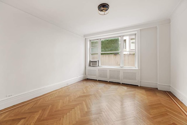 empty room with light parquet flooring and cooling unit