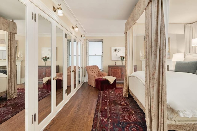 bedroom with crown molding and dark wood-type flooring