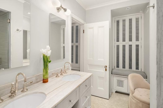 bathroom featuring tile patterned flooring, ornamental molding, and vanity