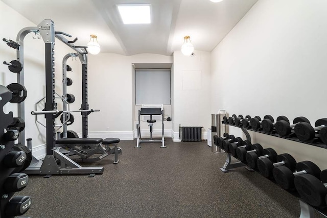 workout area with lofted ceiling and radiator