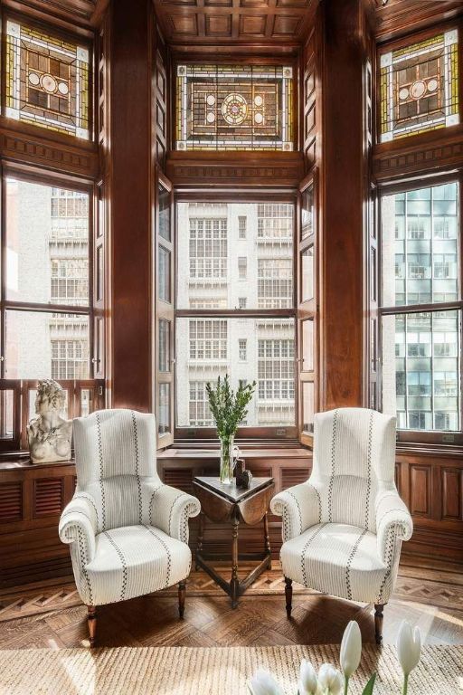 sitting room with parquet floors and wood walls