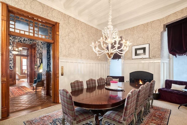 dining room with crown molding, carpet flooring, and an inviting chandelier