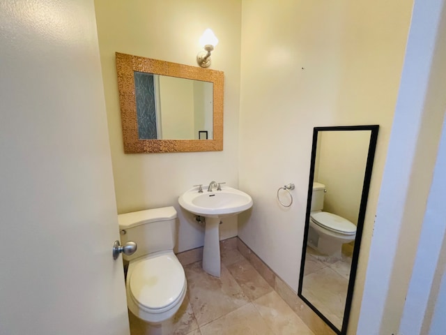 bathroom with tile patterned flooring, sink, and toilet