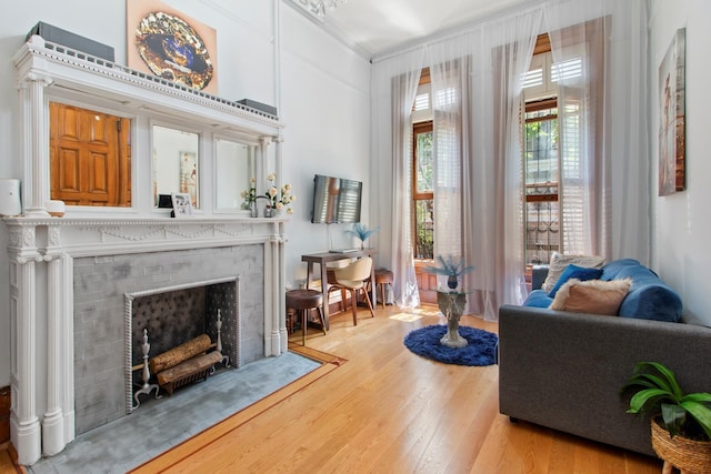 119 W 85th St Unit 2F, New York City, NY 10024 - living room featuring wood finished floors, a fireplace with flush hearth, and crown molding