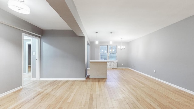 interior space with a chandelier and light hardwood / wood-style flooring