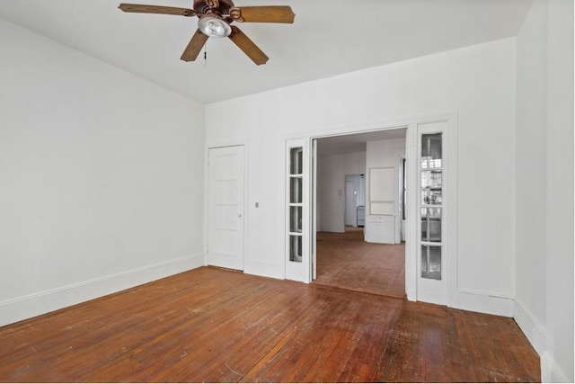 empty room with hardwood / wood-style flooring and ceiling fan