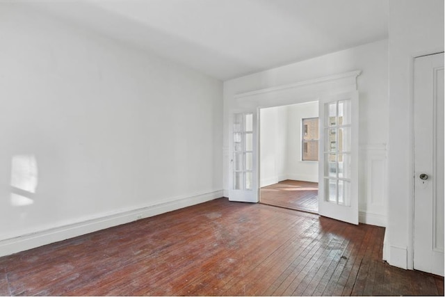 unfurnished room with french doors and dark hardwood / wood-style flooring