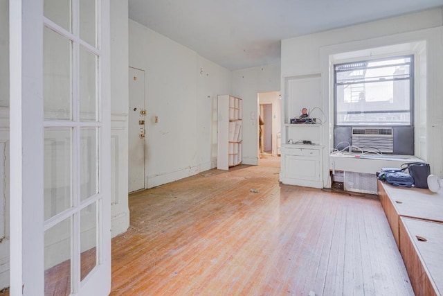 home office with cooling unit and light hardwood / wood-style flooring