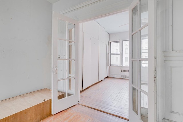 hall featuring french doors and light hardwood / wood-style flooring