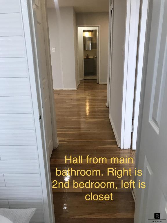 hallway with dark hardwood / wood-style flooring