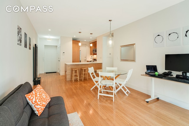 dining room featuring recessed lighting, baseboards, and light wood-style flooring