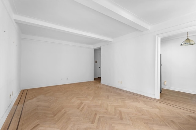 unfurnished room with light parquet flooring and beamed ceiling