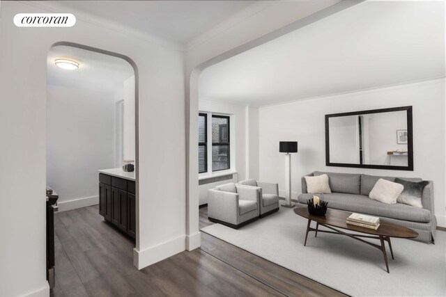 3245 Perry Ave Unit 5F, New York City, NY 10467 - living area with baseboards, dark wood-type flooring, visible vents, and crown molding