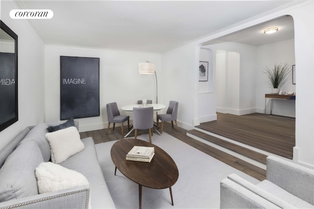 living room with wood-type flooring and crown molding