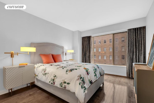 bedroom with dark hardwood / wood-style floors