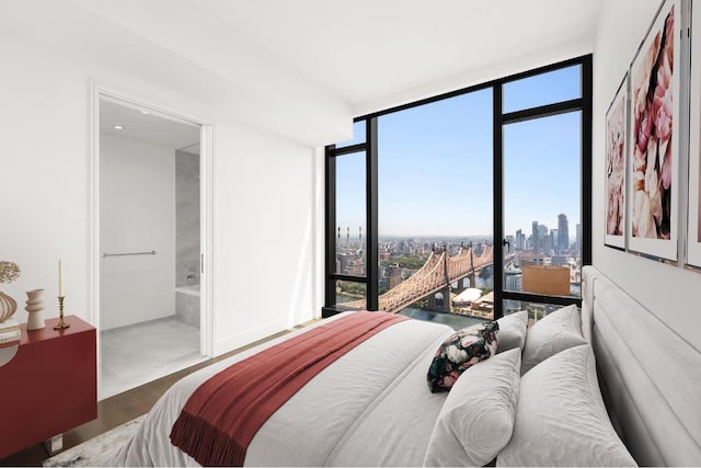 bedroom featuring connected bathroom and floor to ceiling windows