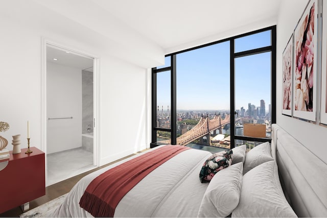 bedroom featuring a city view, wood finished floors, floor to ceiling windows, and multiple windows