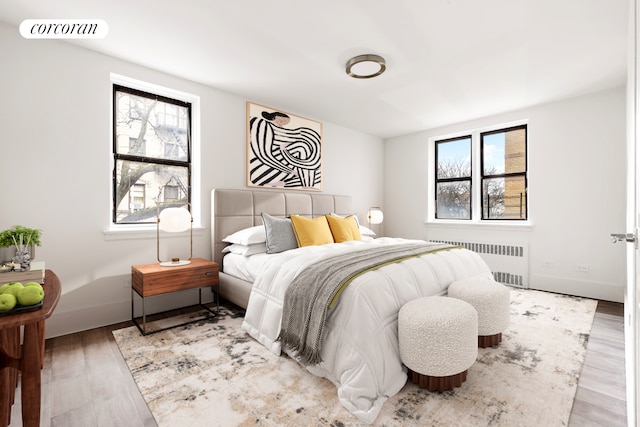 2420 Morris Ave Unit 6E, New York City, NY 10468 - bedroom with radiator and wood finished floors