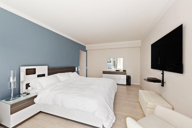 bedroom featuring crown molding and light wood-type flooring