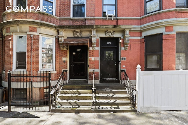 doorway to property with brick siding