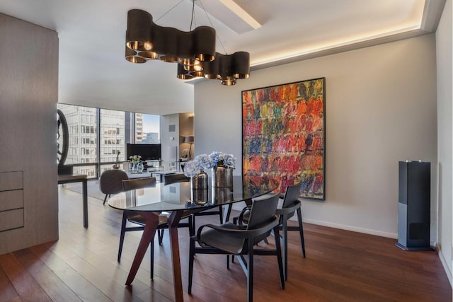 dining space with hardwood / wood-style floors and a chandelier