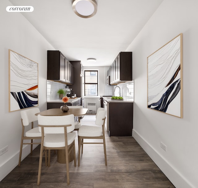 dining area with radiator, visible vents, dark wood finished floors, and baseboards