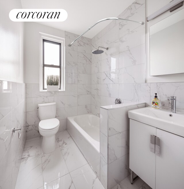 2420 Morris Ave Unit 2E, New York City, NY 10468 - full bath with tile walls, toilet, marble finish flooring, vanity, and bathtub / shower combination