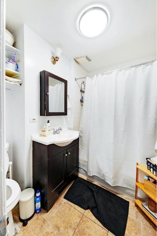 bathroom featuring shower / bath combination with curtain and vanity