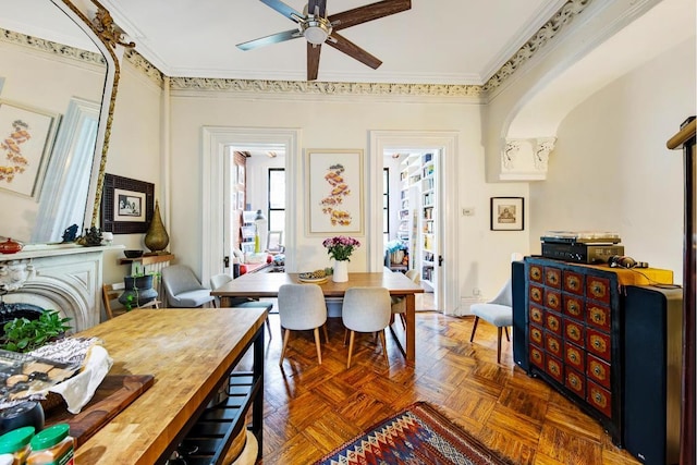 home office with ceiling fan, ornamental molding, and dark parquet flooring