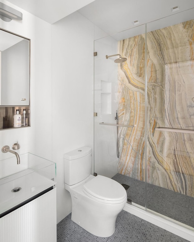 full bath featuring tile patterned flooring, a shower stall, vanity, and toilet