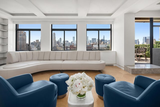 living area with a wealth of natural light, beam ceiling, and a city view