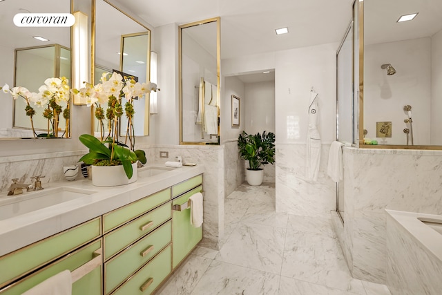 bathroom featuring walk in shower, vanity, and tile walls