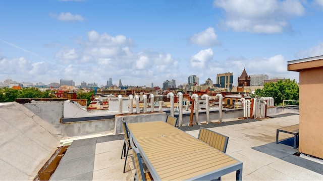 view of patio featuring outdoor dining space and a city view