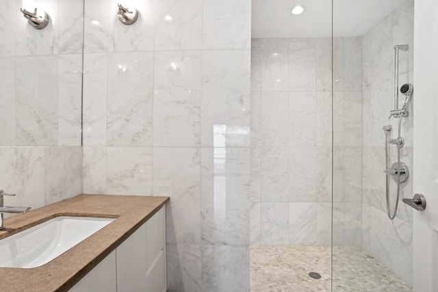 bathroom featuring recessed lighting, a walk in shower, and vanity