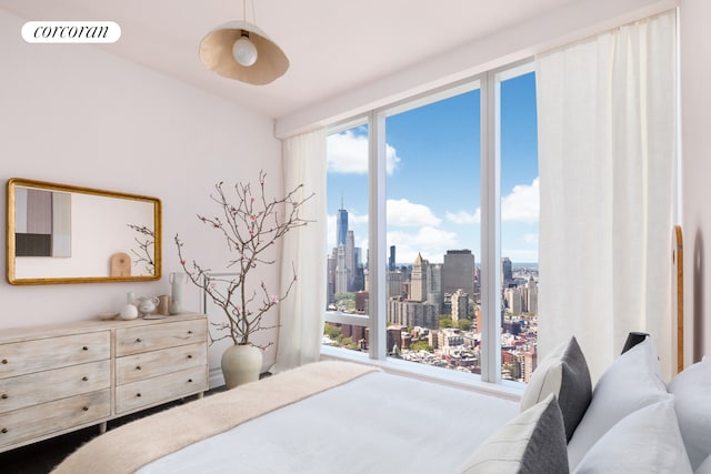 bedroom with visible vents and a city view