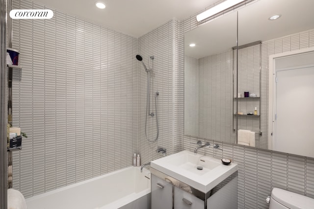 full bathroom featuring shower / bathing tub combination, toilet, vanity, tile walls, and recessed lighting