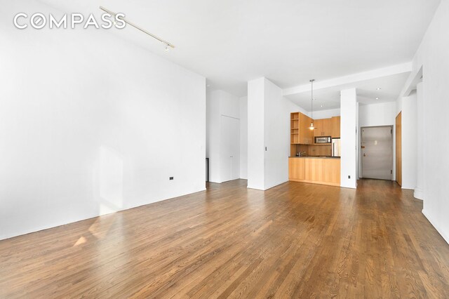 unfurnished living room with dark hardwood / wood-style flooring