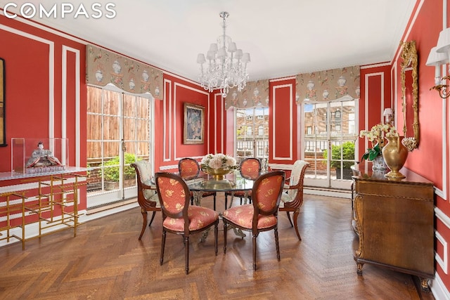 dining room featuring an inviting chandelier, crown molding, dark parquet floors, and a baseboard radiator