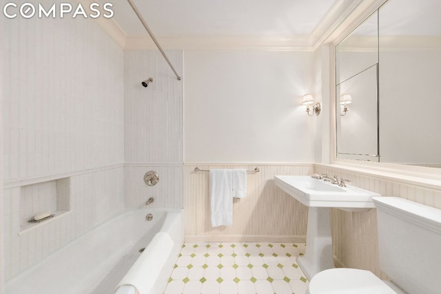 bathroom featuring ornamental molding and toilet