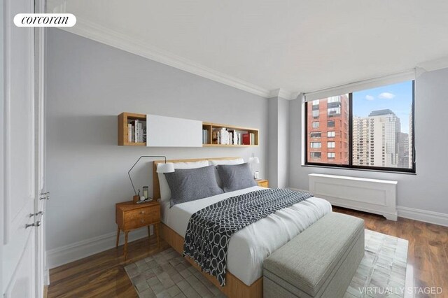 bedroom featuring ornamental molding and dark hardwood / wood-style floors