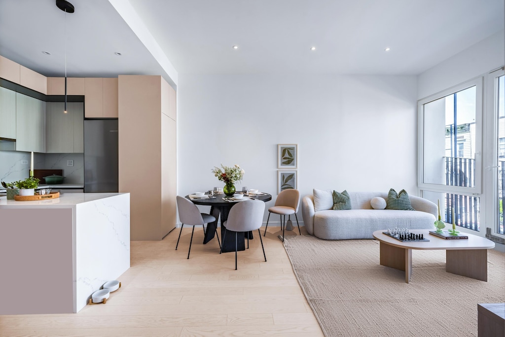 living area with light wood-type flooring, plenty of natural light, and recessed lighting