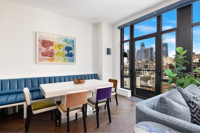 dining room with expansive windows, dark parquet floors, and breakfast area