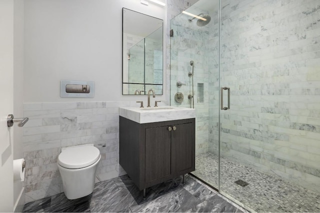 bathroom featuring tile walls, vanity, a shower with door, and toilet