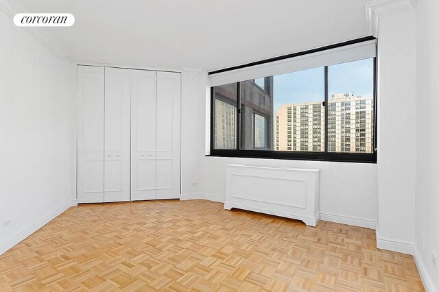 unfurnished bedroom featuring light parquet floors